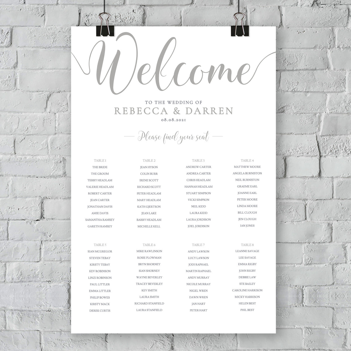 silver seating chart on wall at an outdoor wedding