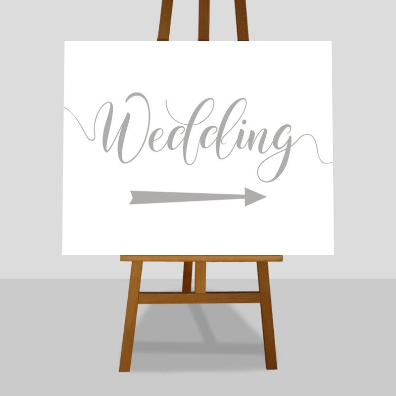 silver wedding arrow sign on easel
