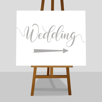 silver wedding arrow sign on easel