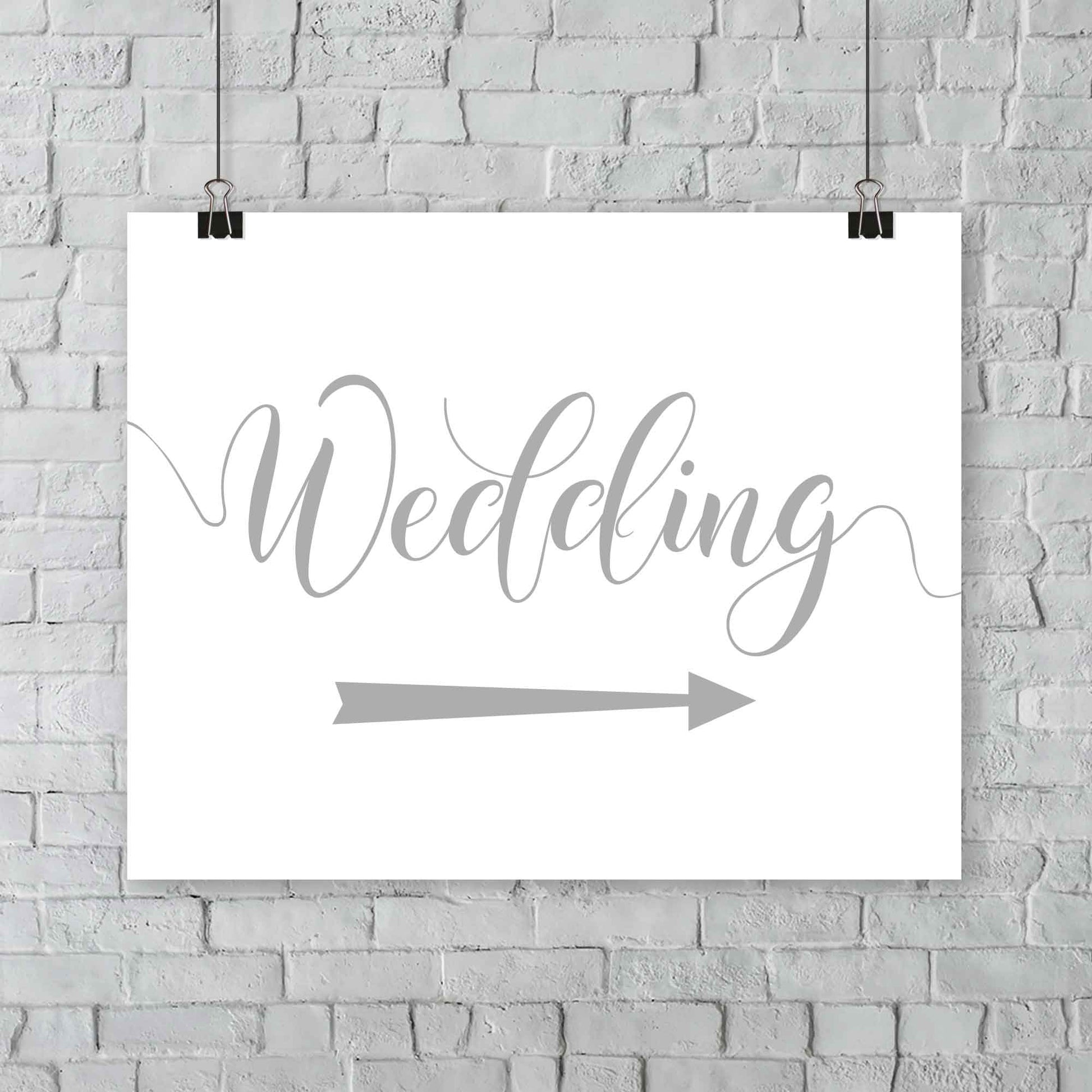 silver wedding arrow sign print hanging from a wall