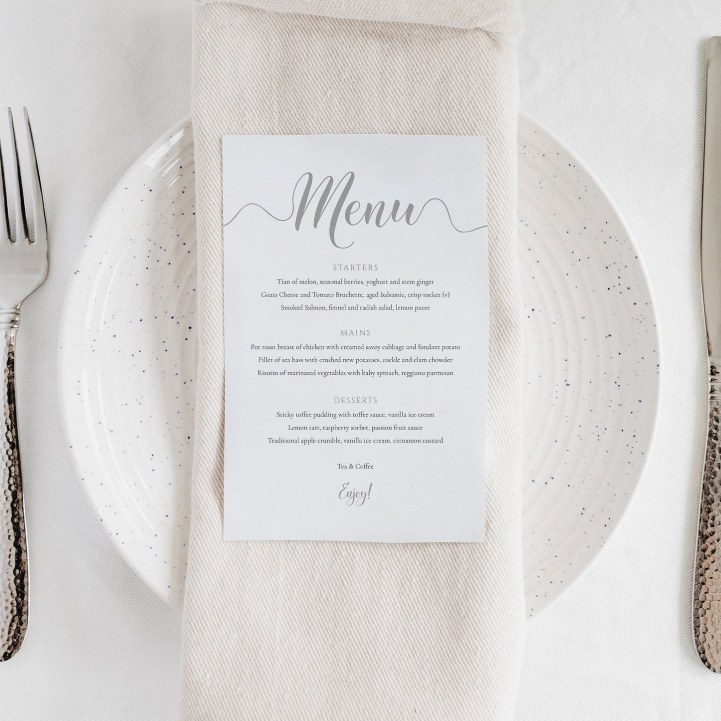 silver wedding menu card on a serviette and plate