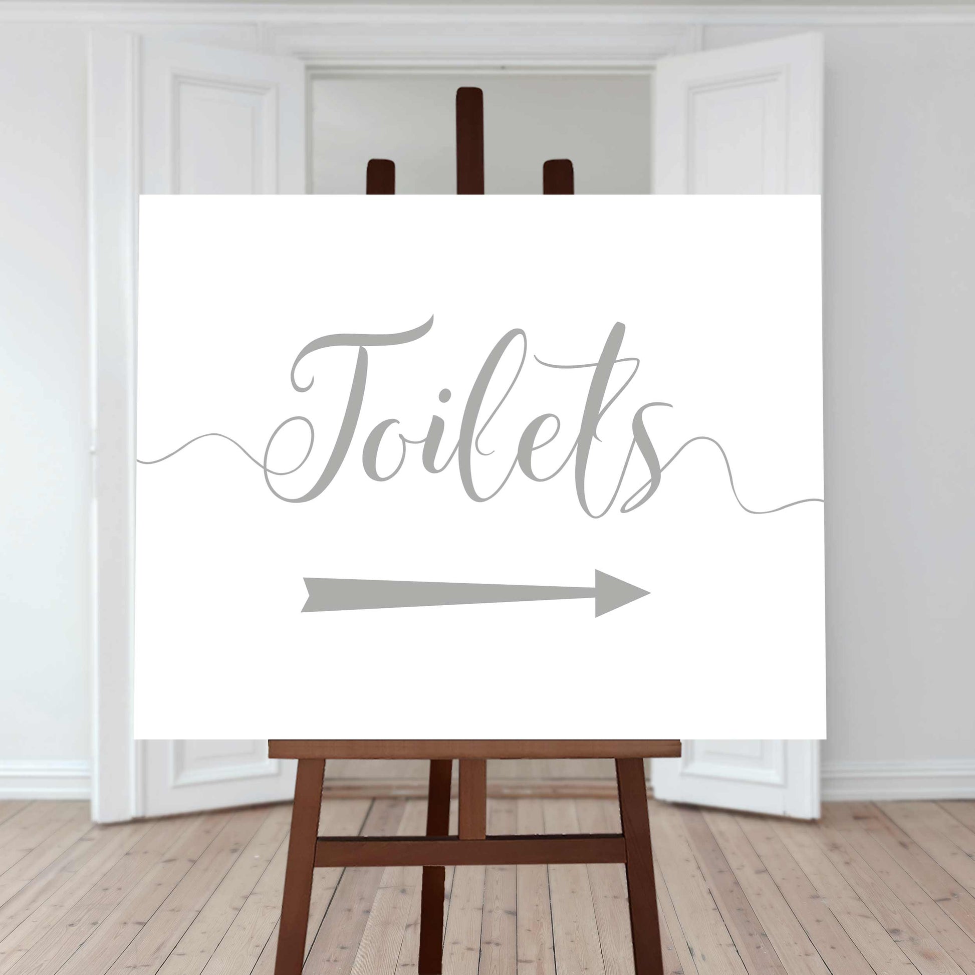 silver wedding toilet directions sign with an arrow pointing right