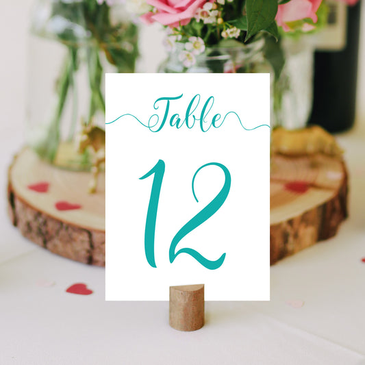 teal table number on a wedding table