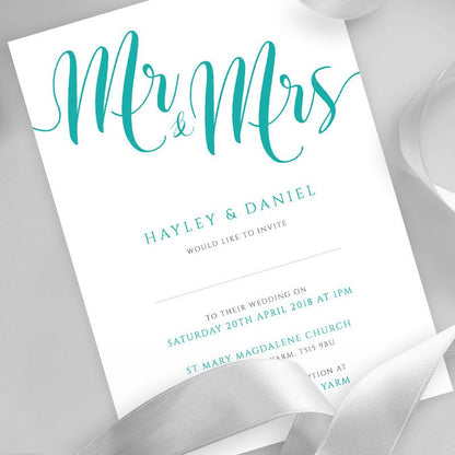 teal wedding invitation printed on white card with ribbons overlayed