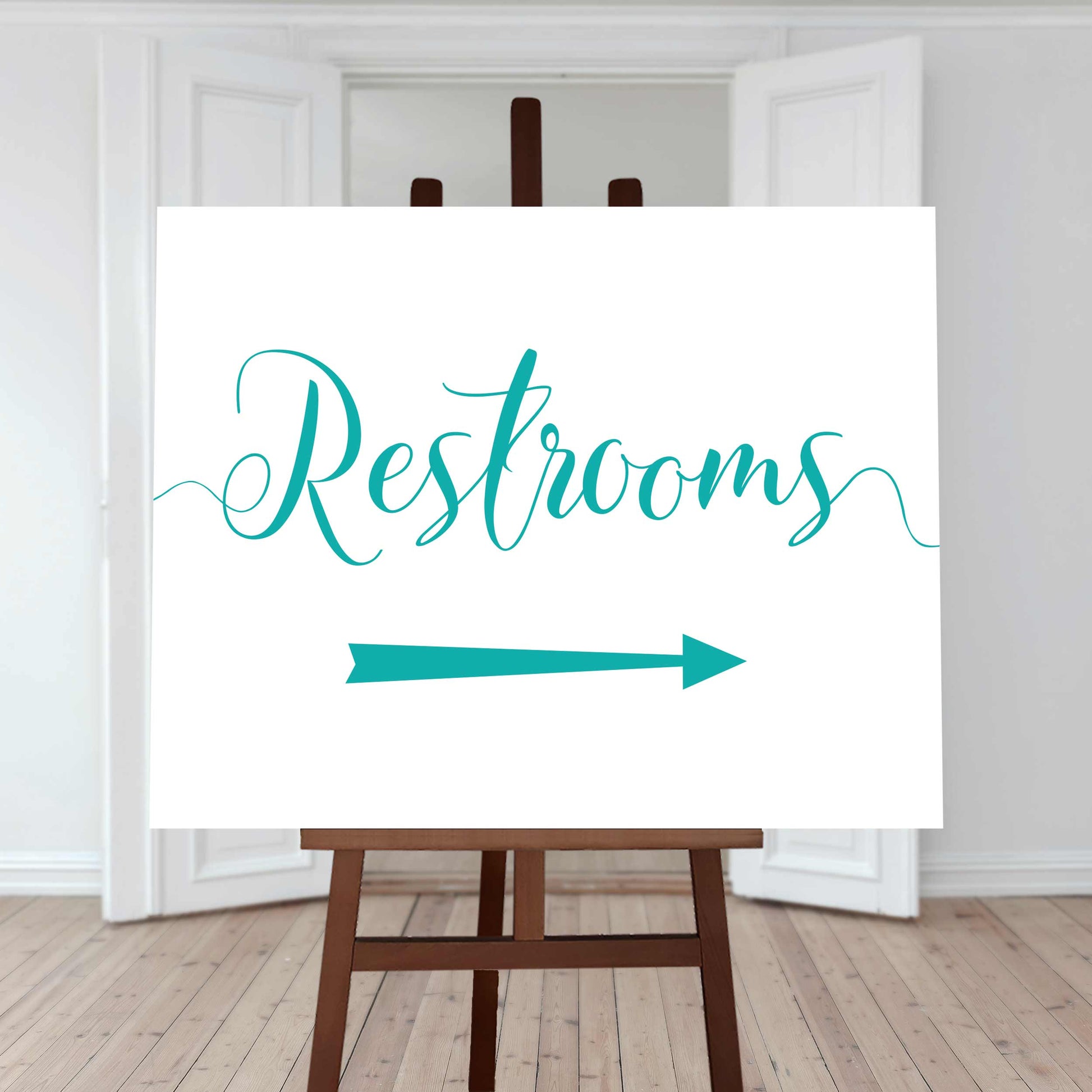 turquoise restroom directions sign with an arrow pointing right