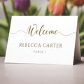 gold folded place cards on wedding table
