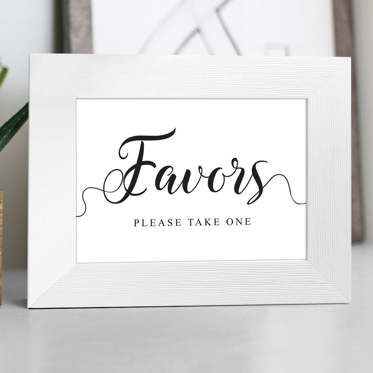Display the Wedding Favors Sign - Instant Download in a white photo frame with elegant black script reading Favors, please take one—ideal for your wedding favor table. Instantly download the PDF for easy setup.