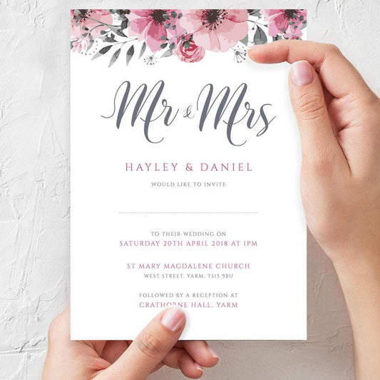 bride-to-be holding a mr & mrs floral wedding invitation